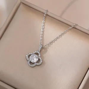 Elegant silver four-leaf flower necklace with sparkling zircon stone on jewelry box