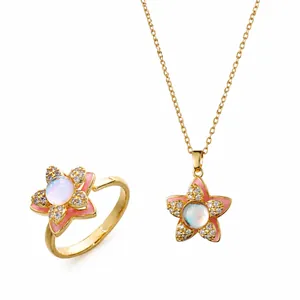 Gold jewelry set featuring pink flower necklace and open ring with zircon and opal