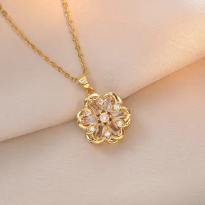 Elegant gold flower rotating zircon pendant necklace on luxury champagne silk fabric