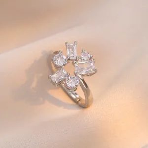 Silver adjustable open ring with geometric zircon stones on elegant silk fabric