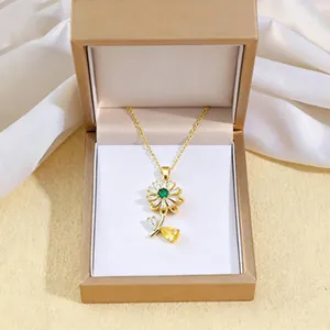 Rotating sunflower necklace with emerald zircon in a premium golden gift box