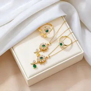Detailed set of golden sunflower necklaces and rings with green crystals and zircons