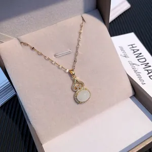 Elegant gold titanium steel gourd necklace with white stone pendant in a velvet box