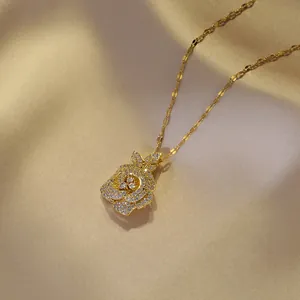 Elegant gold rose pendant necklace with white zircons on premium champagne satin background