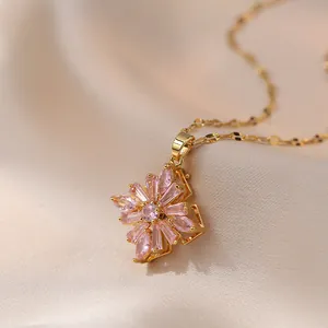 Elegant gold titanium steel necklace featuring a rotating pink zircon floral pendant