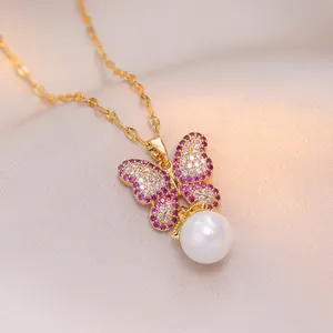 Elegant gold bow necklace with pink crystals and a white pearl on pink satin background
