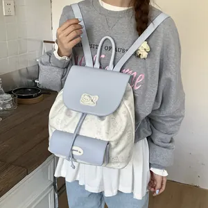 Chic women's backpack in blue and white featuring cute bear prints and a cat patch design