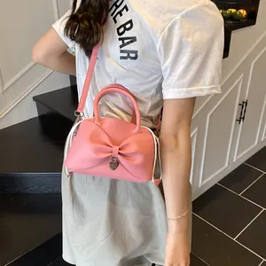 Pink bow bucket bag with heart pendant, stylish crossbody purse for daily wear