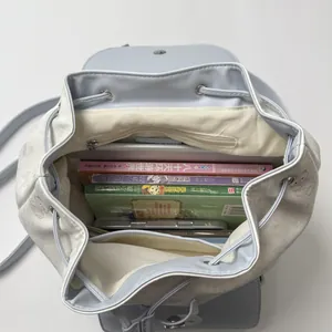 Top view of large capacity blue cat drawstring backpack showing interior with tablet and books