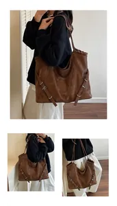 Close-up of brown vintage leather tote bag with silver buckles and minimalist straps