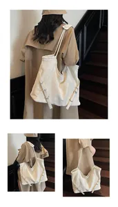 Detail view of large cream tote bag with drawstring closure and slim shoulder straps