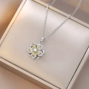 Detailed view of rotating flower pendant with yellow zircon in a premium jewelry box