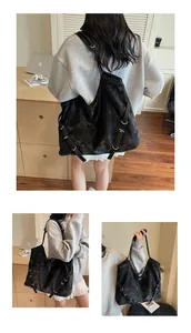 Detailed views of vintage black tote bag with silver metal rings and washed faux leather texture