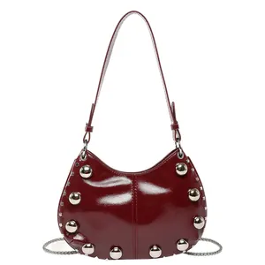 Minimalist dark red patent leather hobo bag with silver metallic studs and chain strap