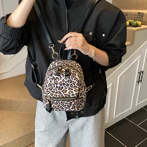 Mini leopard print backpack with gold hardware and front zipper pocket for women