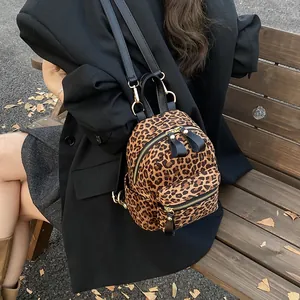 Stylish mini backpack featuring leopard print with gold hardware and black straps