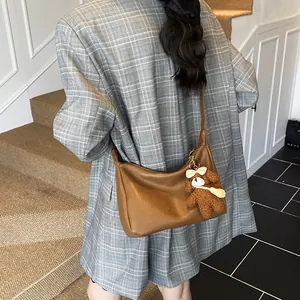 Sac fourre-tout demi-lune marron caramel avec breloque ours en peluche et bandoulière
