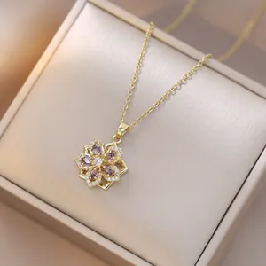 Rotating gold flower necklace with purple water-drop gems and white zircon inlay