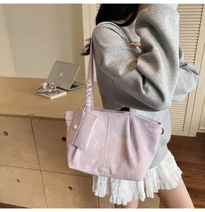 Detail of light purple marble tote bag with woven handle and small matching pouch