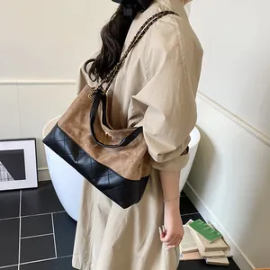 Vintage quilted suede tote bag with leather contrast and chain strap shown on a model