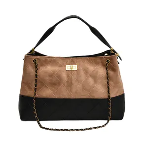 Quilted faux suede tote bag with brown and black panels and a golden turn-lock closure