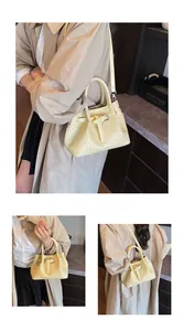 Detail view of woven leather handbag featuring elegant decorative buckle and shoulder strap
