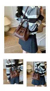 Detailed view of dark brown woven texture handbag with metal buckle and shoulder strap
