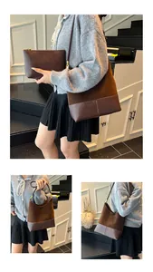 Detail view of brown matte bucket bag set with polished synthetic leather and gold buckle