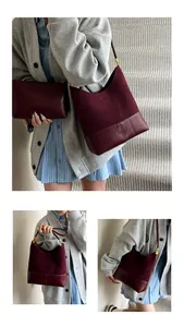Close-up of matte burgundy leather bucket bag and matching clutch set with shoulder strap