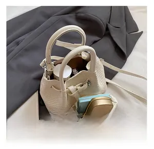 Internal view of the large capacity woven bucket bag showing space for cosmetics
