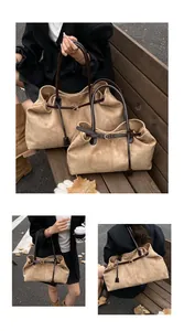 Detail of large suede tote bags with leather straps and metal buckle shown in two sizes