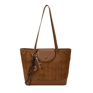 Brown quilted tote bag with checkered pattern and leather patchwork in minimalist style