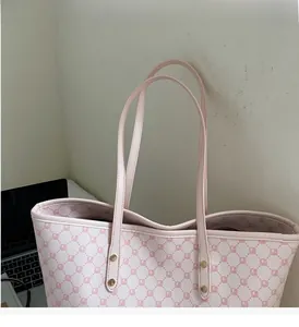 Detailed view of the pink and white checkered tote bag with durable leather handle straps