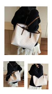 Retro geometric monogram tote bag with brown trim shown in a cozy home setting