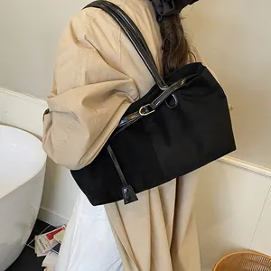 Retro black tote bag featuring mixed leather texture and golden buckle for daily commute