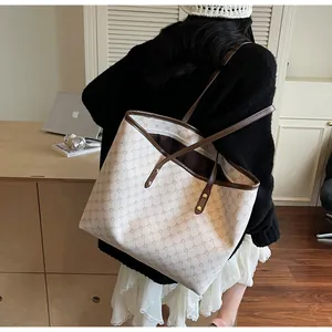 Chic beige tote bag with brown geometric lattice pattern on an office desk setting