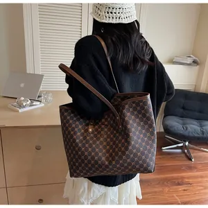 Detailed view of brown tote bag with geometric patterns and leather straps for office use