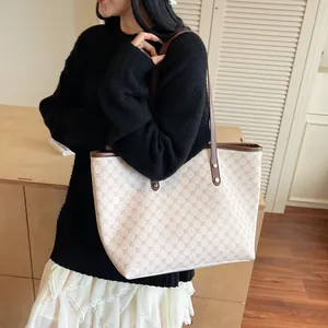 Elegant ivory tote bag with brown monogram pattern and spacious interior for daily use
