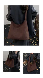 Detail view of large dark brown suede tote bag featuring retro golden adjustable buckles