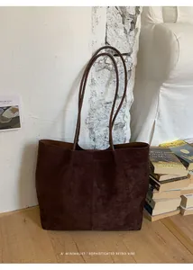Detail of dark brown faux suede tote bag featuring large capacity and soft texture