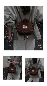 Detail view of brown corduroy backpack with ruffled edge, bear patch, and drawstring
