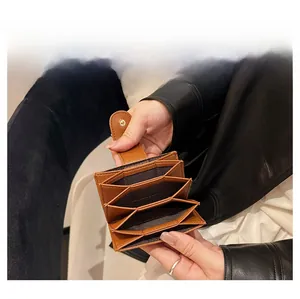 Capacity display of a brown lychee pattern accordion card wallet with metal snap button