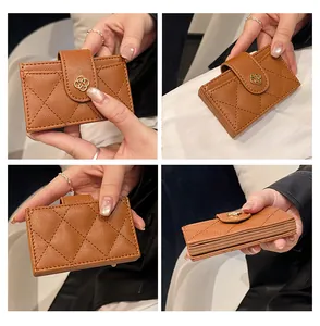 Brown caviar leather wallet with camellia buckle and diamond quilted pattern
