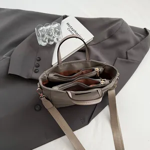 Taupe nylon tote bag with three large compartments and detachable wide shoulder strap