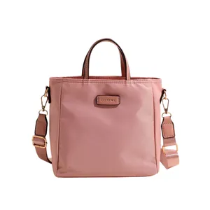 Pink nylon tote bag with circular handles and adjustable shoulder strap for women