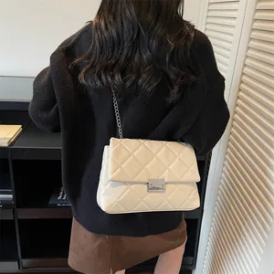 Quilted cream shoulder bag with silver chain strap and metallic clasp closure for women