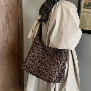 Retro leopard print triangle tote bag shown on a model in a vintage interior setting