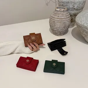 Quilted leather card holder with camellia buckle in black, brown, red, and green