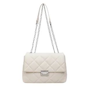 Beige quilted leather crossbody bag with silver metal chain strap and elegant turn-lock