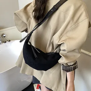 Minimalist black suede crescent crossbody bag with adjustable leather strap for women